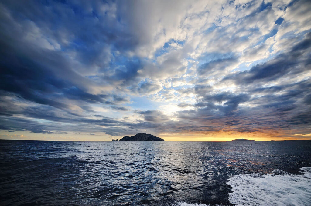Afternoon view of Parthenope Yacht anchored in Procida with a scenic backdrop