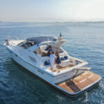 Guests helping the crew aboard a yacht in the beautiful open sea